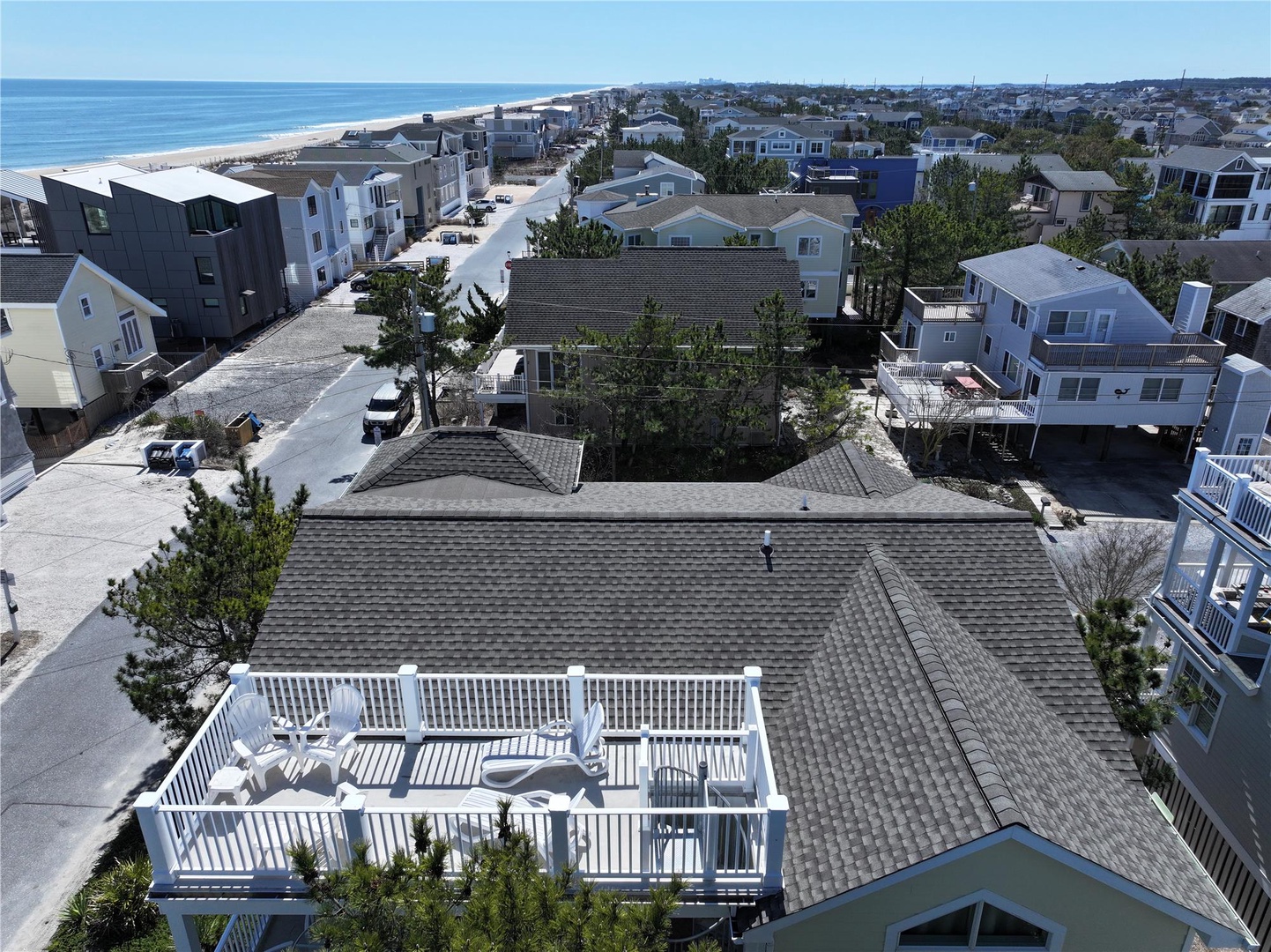 Coastal vacation home situated in a beachside neighborhood, moments from sandy shores and ocean waves, surrounded by beach community charm.