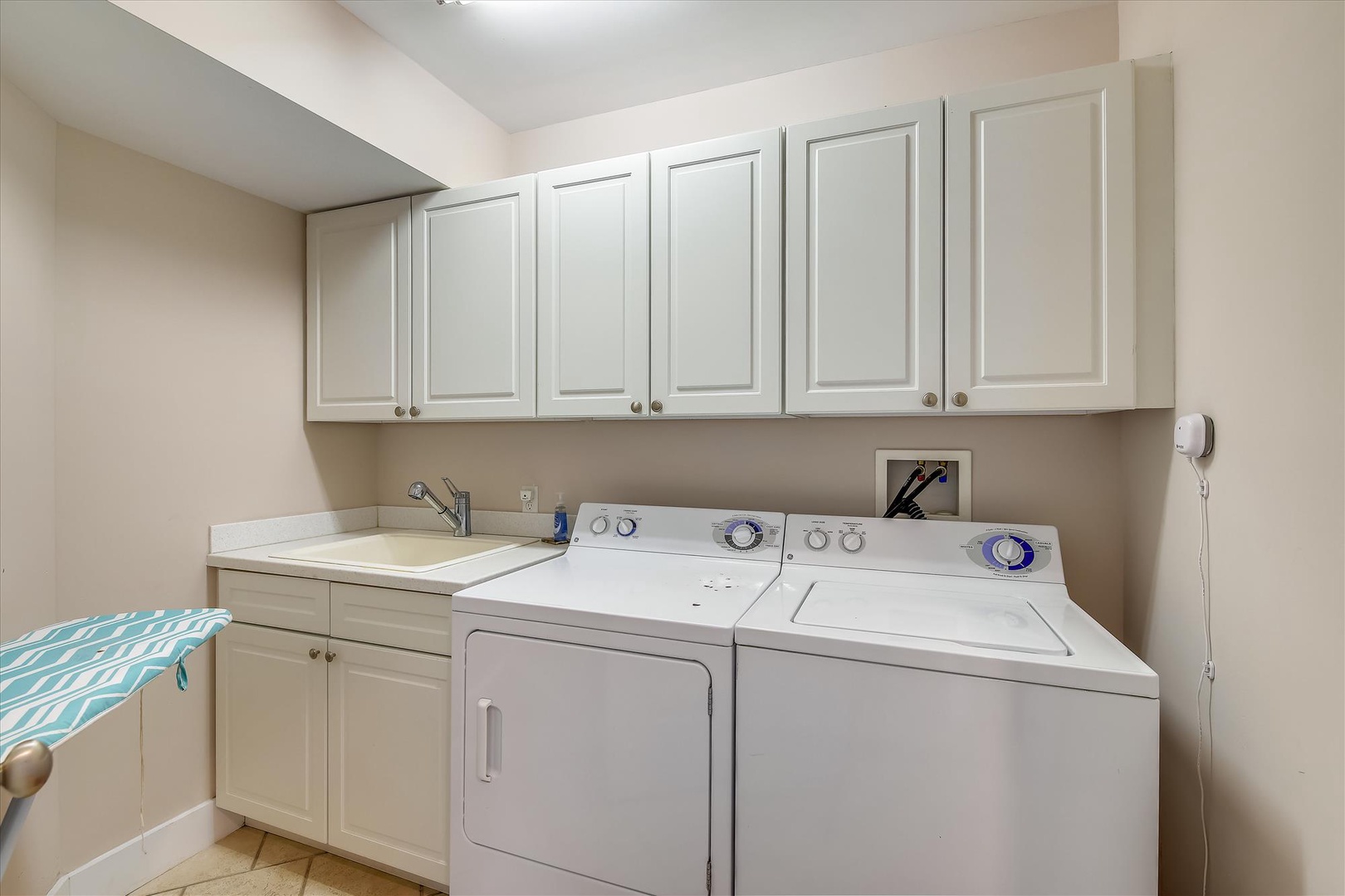 Pack light and refresh easily with your own in-unit laundry room, featuring full-size washer and dryer, a utility sink, and generous cabinet storage.