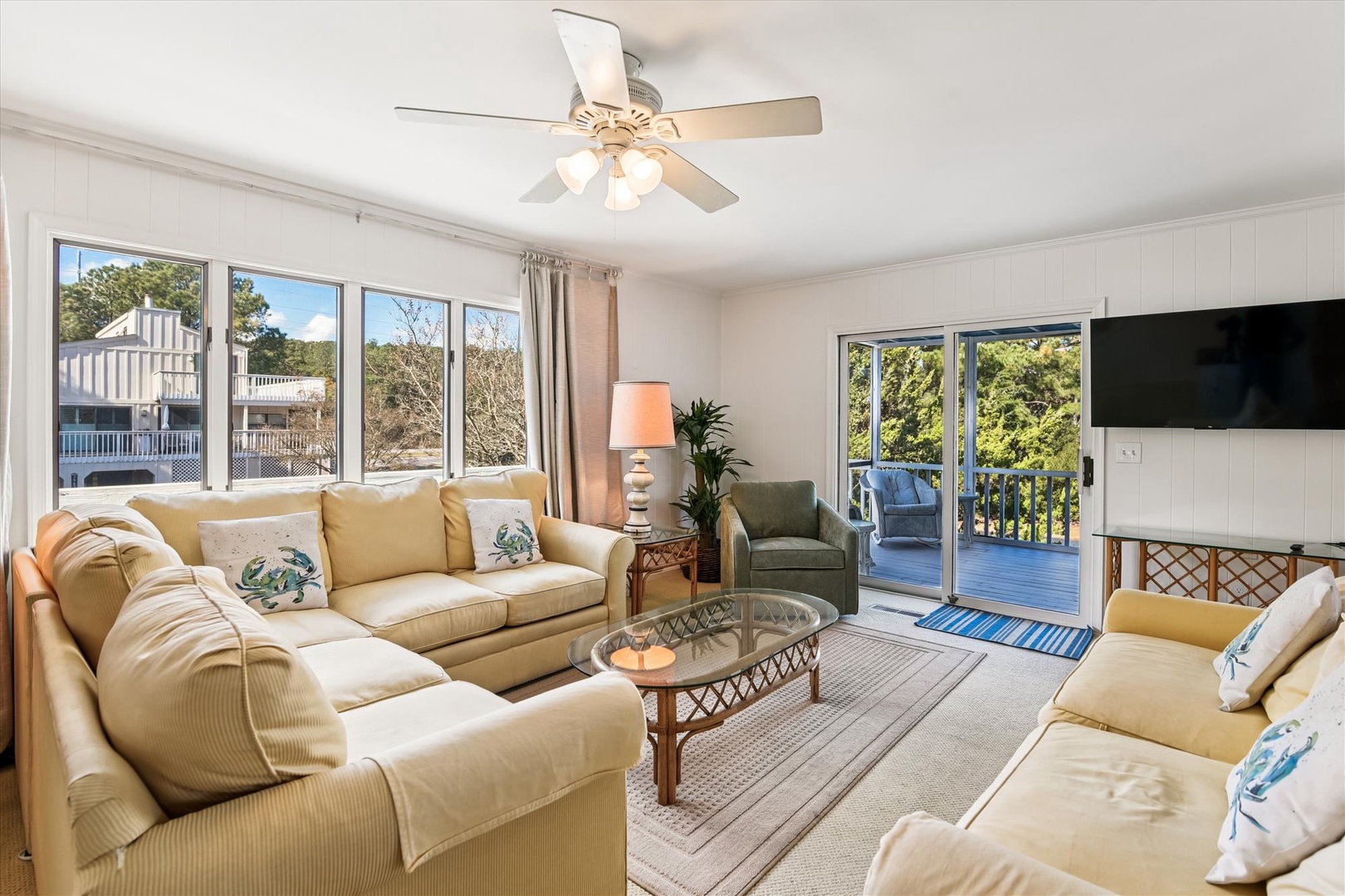 Sink into plush sofas while the ceiling fan keeps you cool. Your bright living space opens to a private balcony with treetop views.