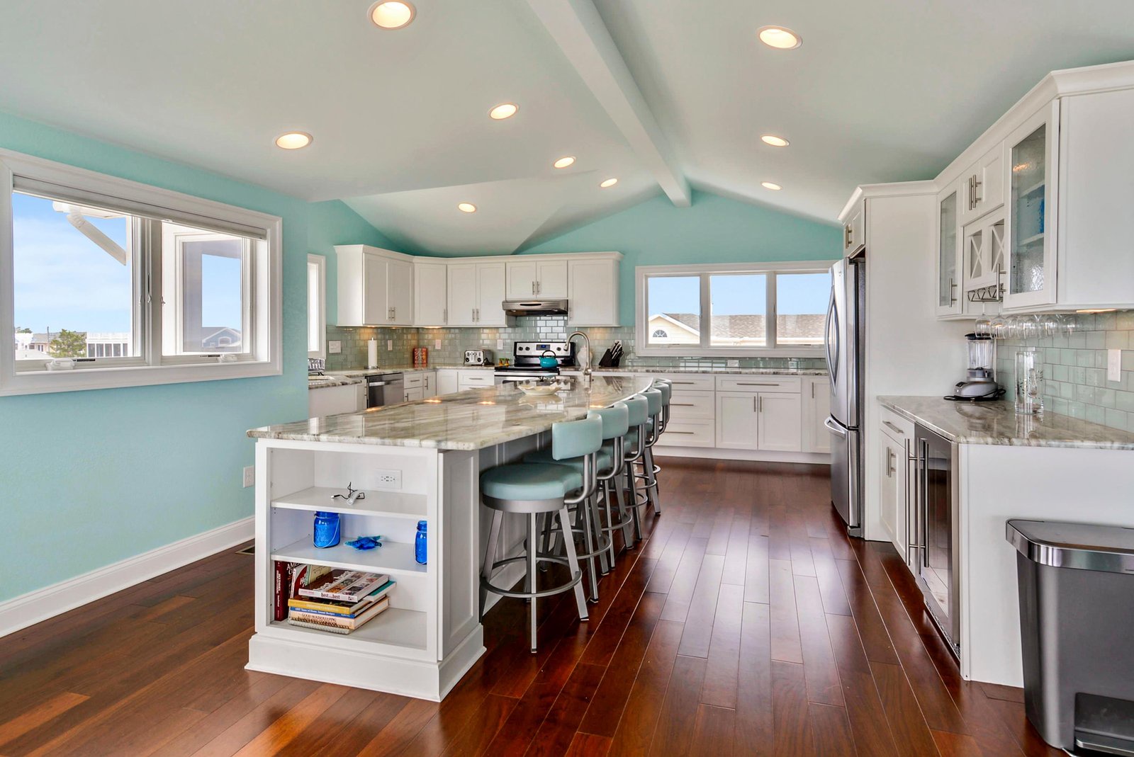 Gather with loved ones in your spacious gourmet kitchen, featuring gleaming white cabinetry, granite countertops, and a large island perfect for meal prep and conversation.
