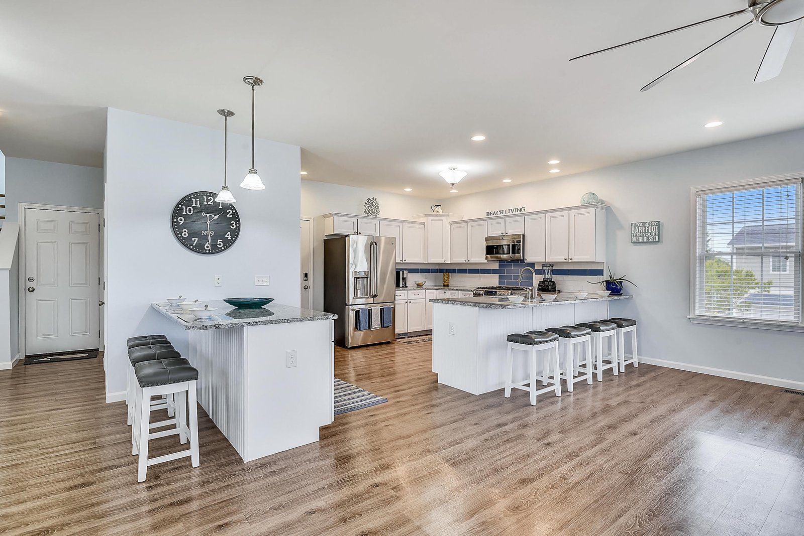 Gather around your spacious kitchen island for morning coffee or casual meals. The open layout and modern finishes create the perfect setting for relaxed vacation living.