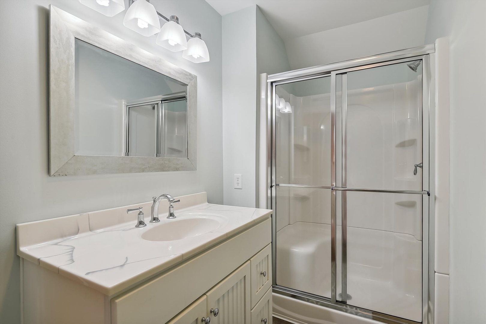Refresh in your private bathroom with a spacious walk-in shower, elegant vanity, and soft lighting perfect for morning routines or winding down after exploring.