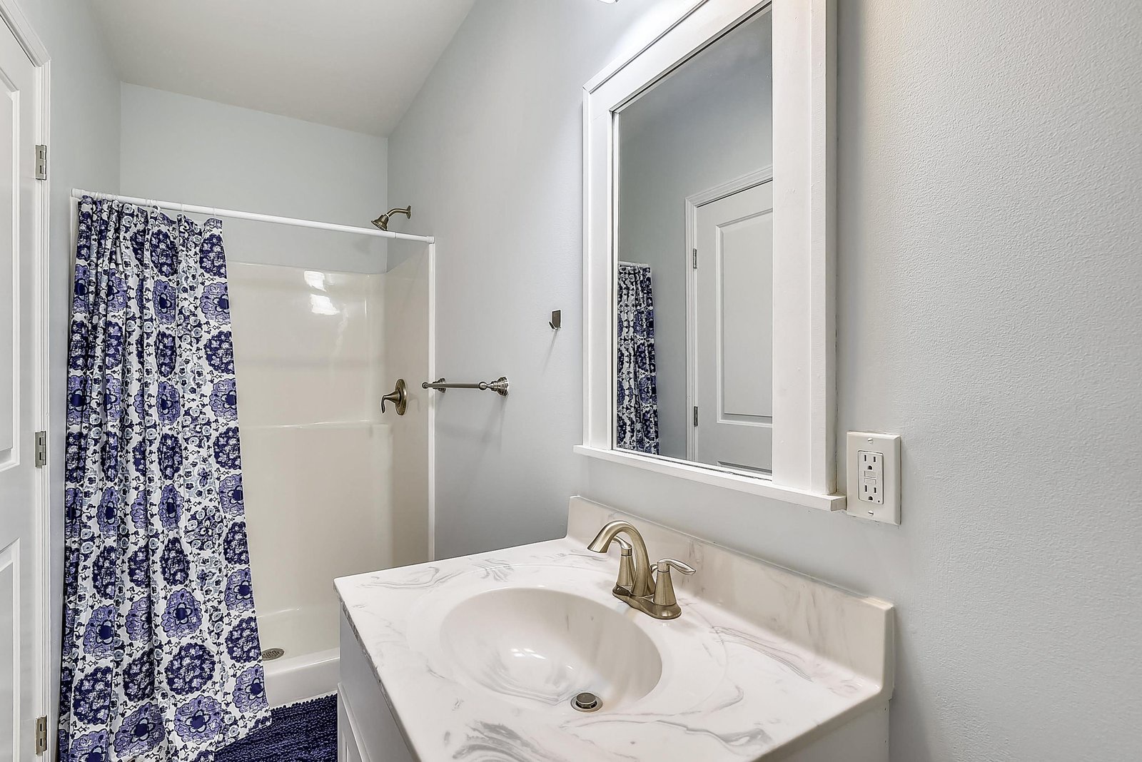 Refresh in this clean, bright bathroom with a spacious shower and elegant marble countertop—your peaceful retreat after a day of exploring.