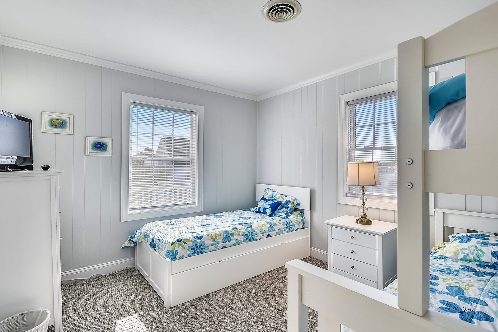 Sink into the soft bedding and relax in your serene bedroom retreat, where coastal hues and natural light create a peaceful sanctuary for restful nights.