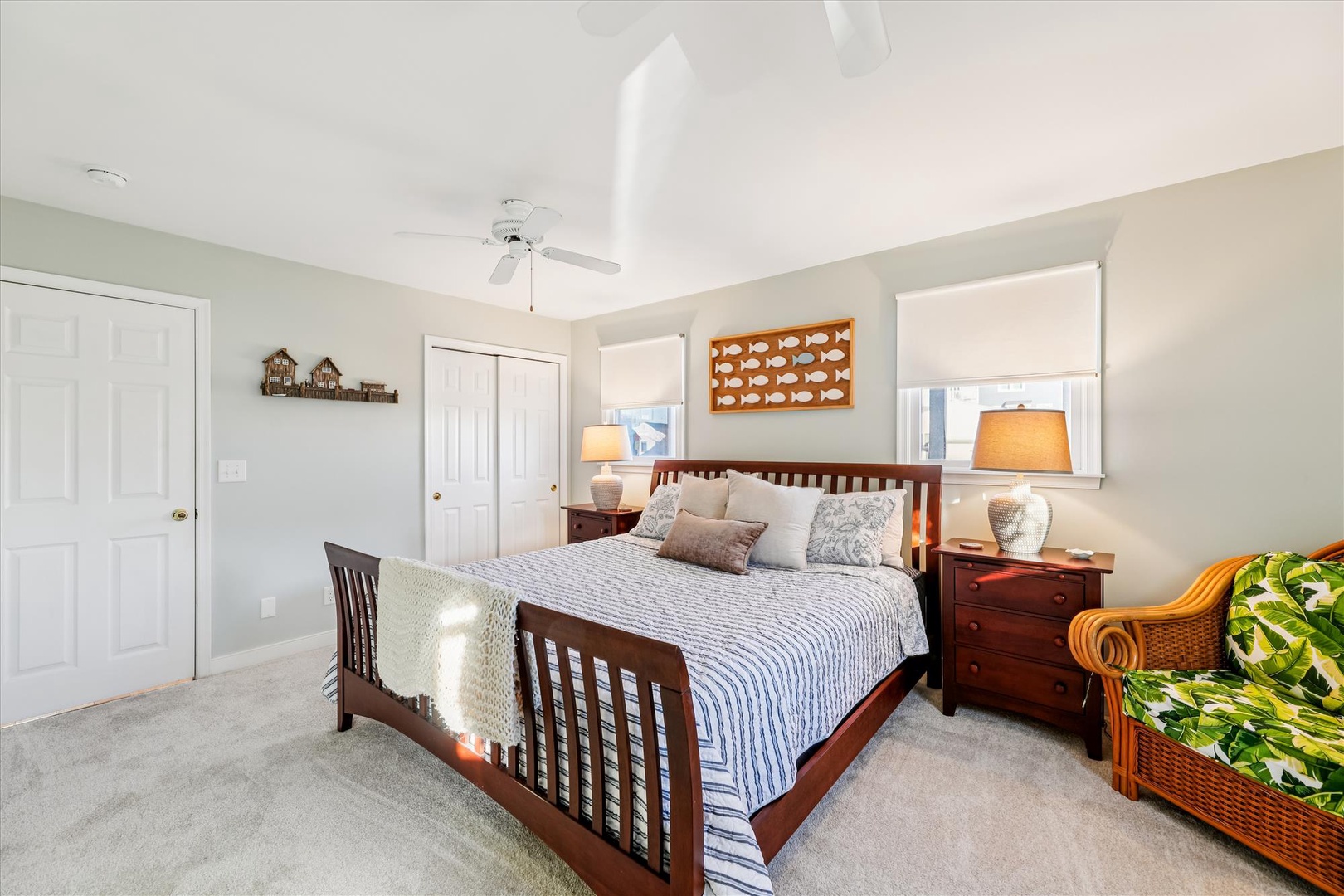 Relax in your peaceful bedroom with comfortable bedding, warm wood furnishings, and gentle natural light from large windows.