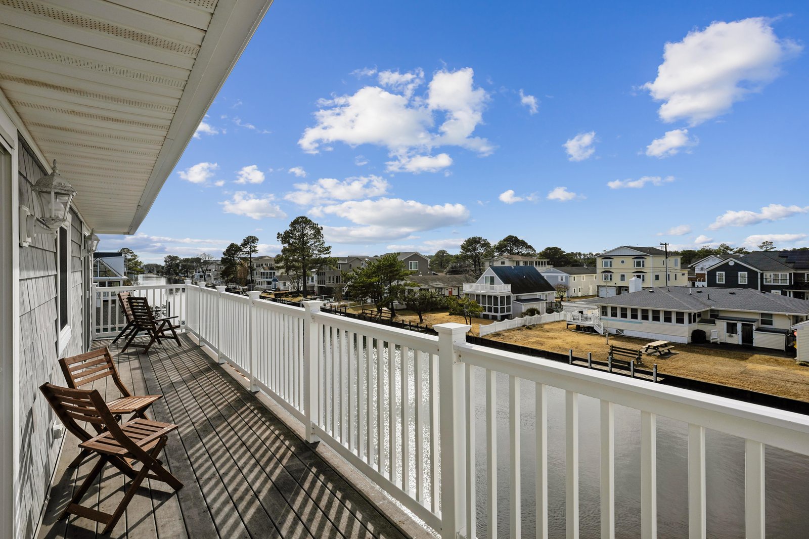Settle into your private balcony with morning coffee and soak in the expansive rooftop views of this charming coastal neighborhood, where blue skies meet tree-lined streets.