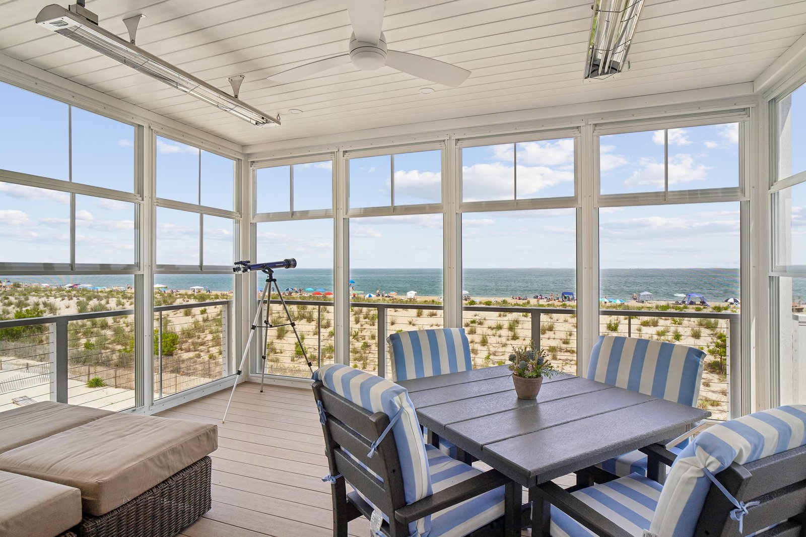 Unwind in your private sunroom where floor-to-ceiling windows frame endless ocean views and coastal breezes sweep through the space—perfect for morning coffee or sunset dinners.