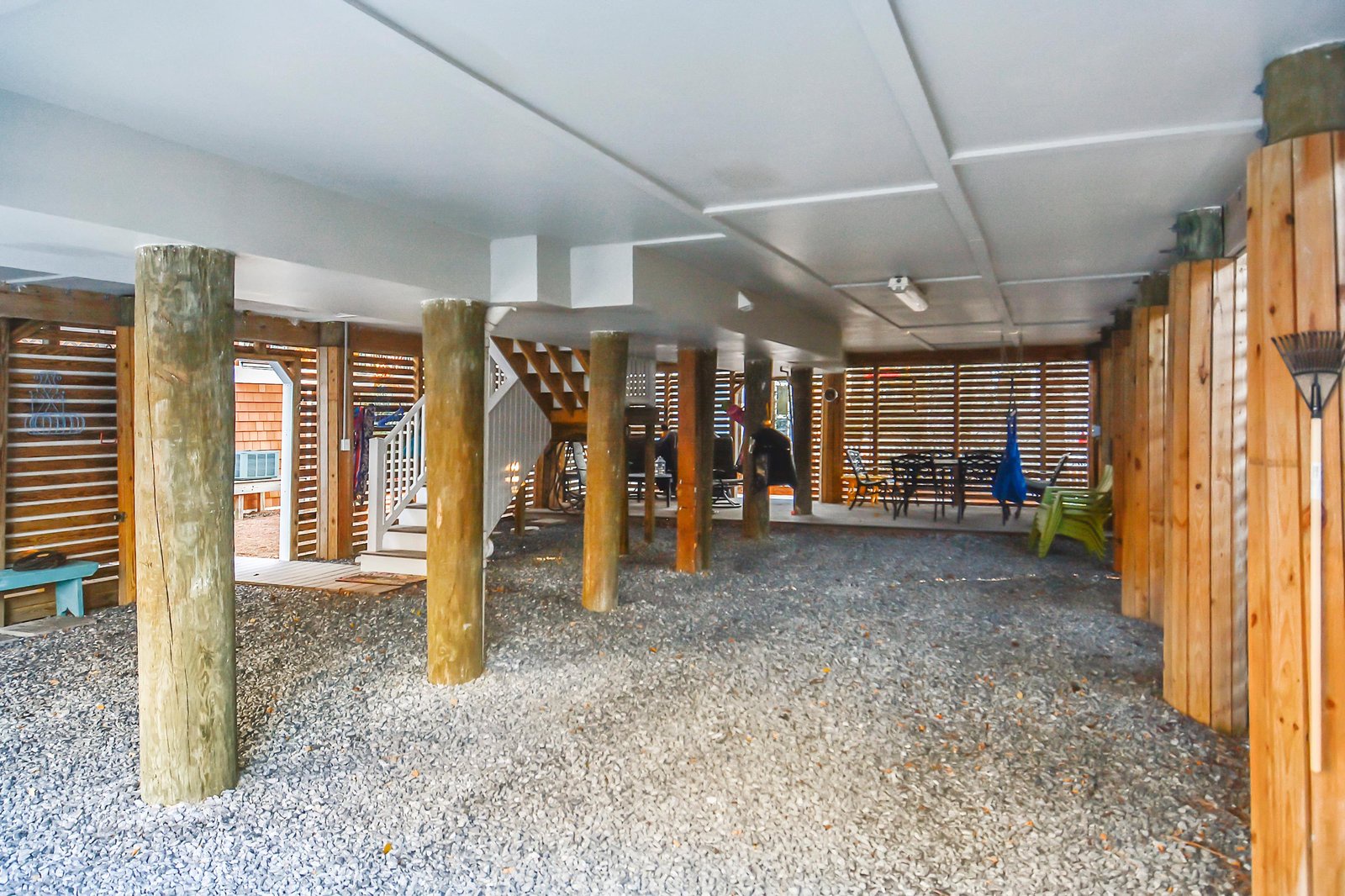 The property features a sheltered outdoor area with natural wood posts and gravel flooring, connecting to the surrounding neighborhood and providing easy access to nearby attractions.