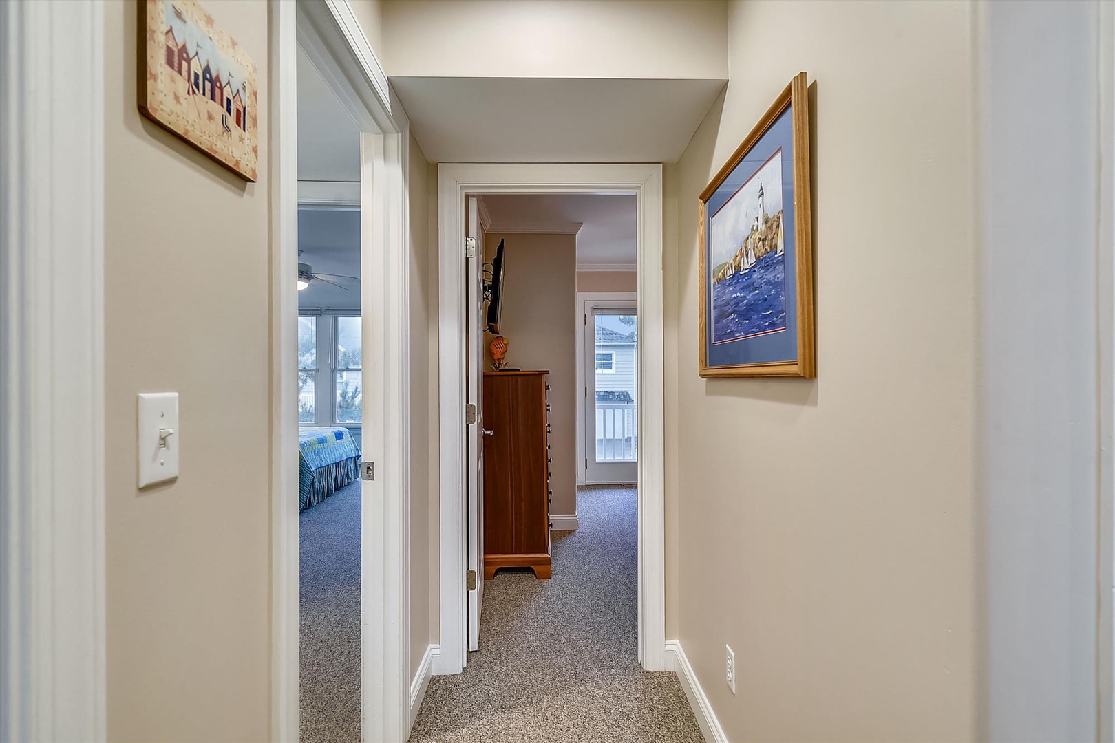 Step into your serene hallway, where soft carpeting and clean lines guide you to cozy bedrooms and private spaces. Thoughtful decor and natural light create a warm, welcoming retreat.