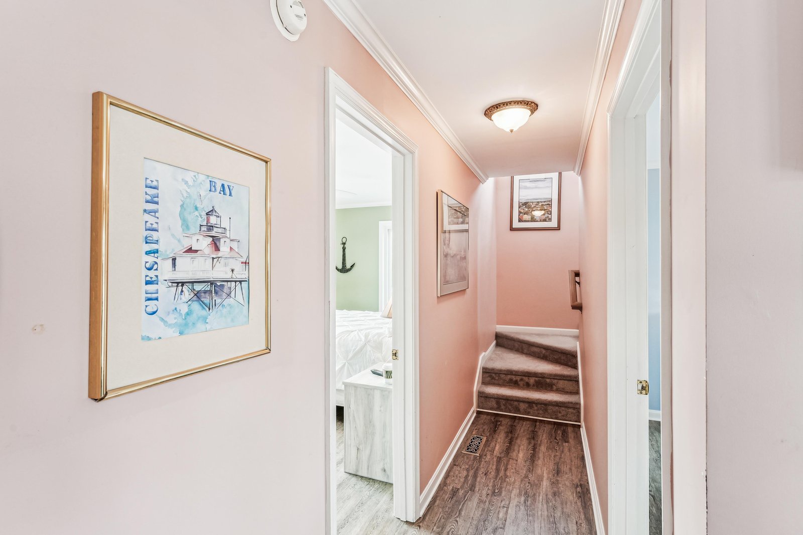 A welcoming hallway painted in soft coastal hues leads you to your private spaces, with thoughtful nautical touches that set a relaxed, beachy tone from the moment you arrive.