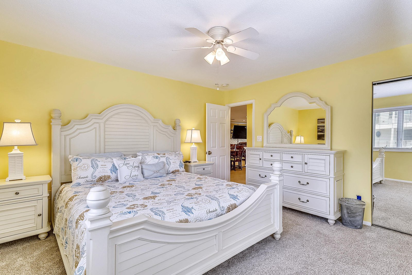Rest easy in your cheerful coastal bedroom with sunny walls, a ceiling fan for comfort, and all the space you need to unwind after a day of adventure.