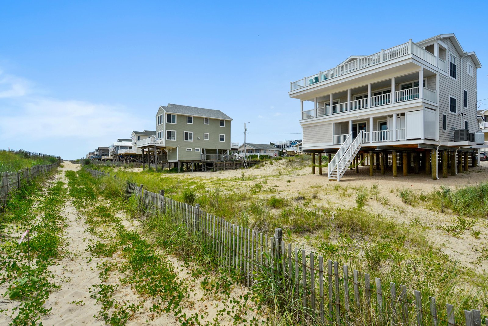 The property sits just steps from the sandy shore, offering direct beach access and coastal living in a peaceful beachfront community.