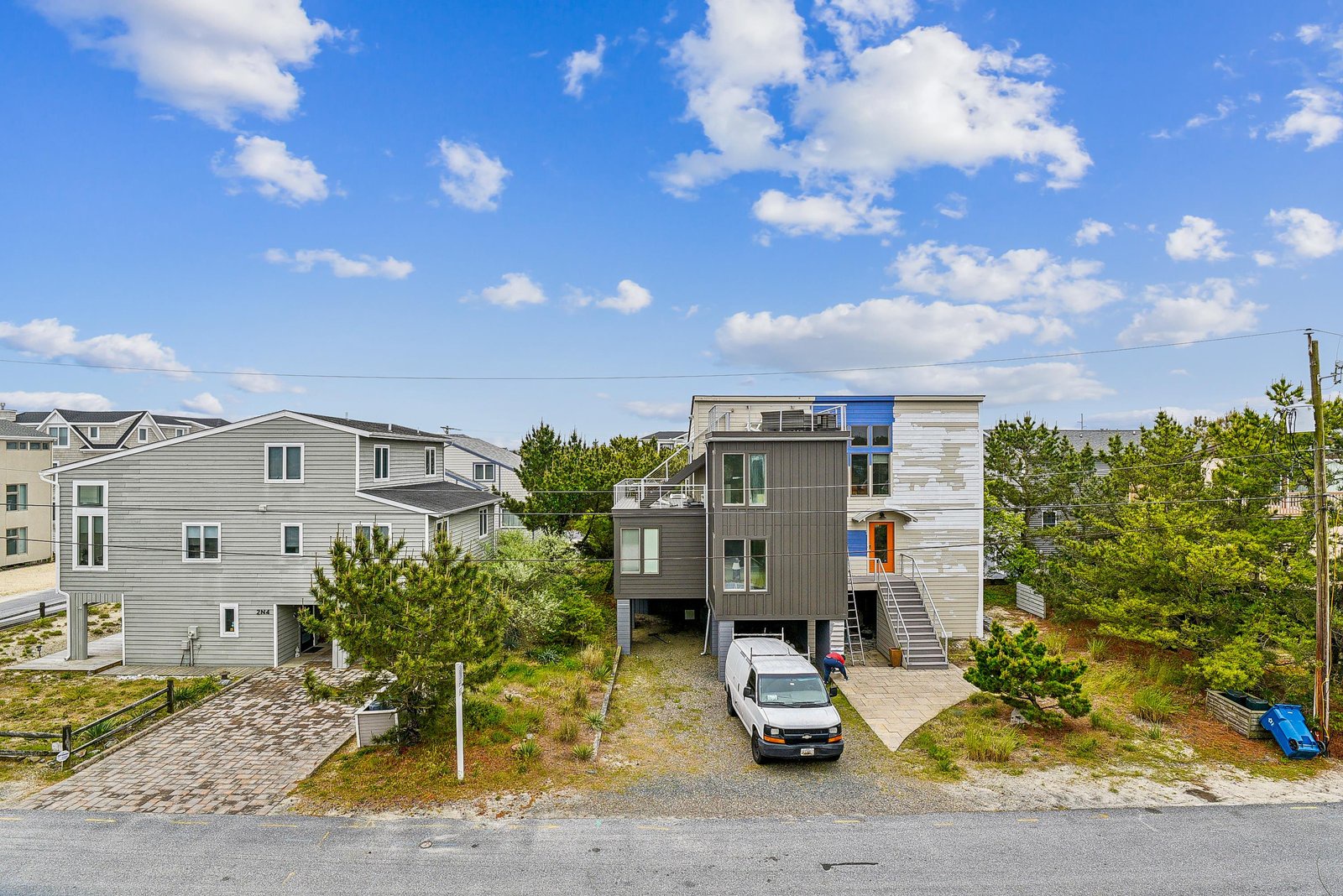Modern beachside property nestled in a peaceful coastal neighborhood, featuring contemporary design and convenient parking just steps from the shore.