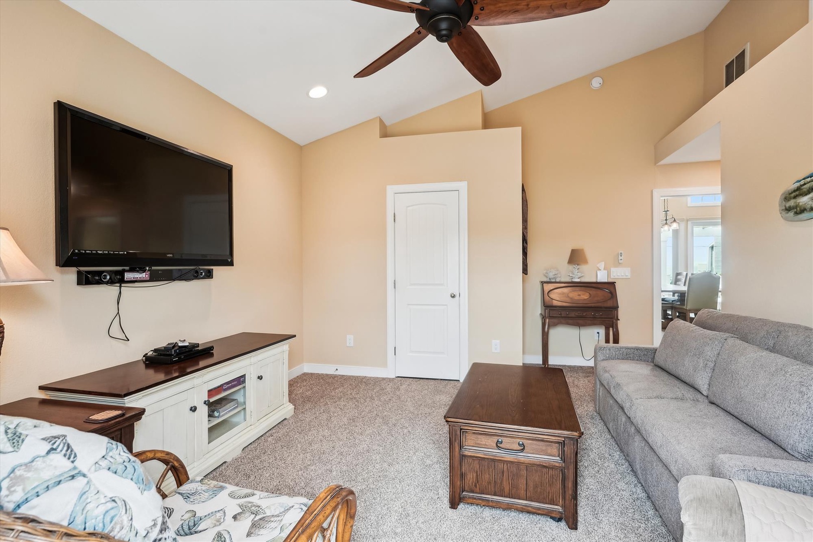 Settle into your cozy living room, where high ceilings and soft lighting create an inviting space for unwinding after your adventures. The large flat-screen TV is ready for your favorite shows.