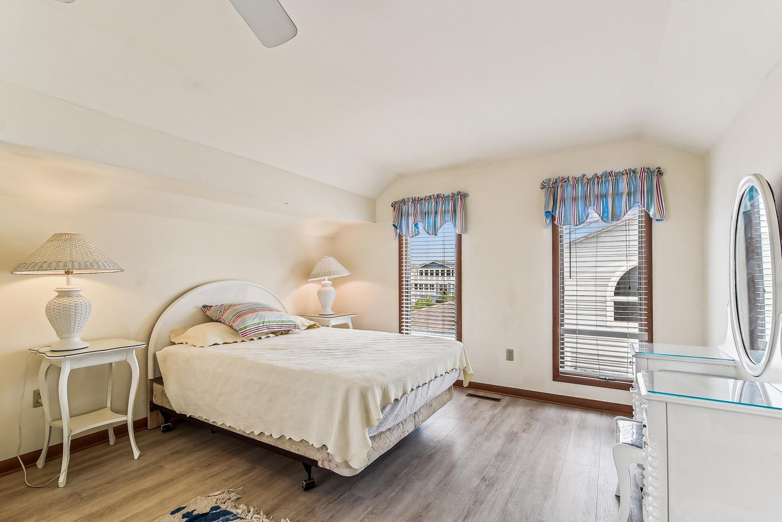 Wake to soft morning light streaming through large bedroom windows. Hardwood floors and elegant furnishings create a serene retreat where you'll look forward to every restful night.