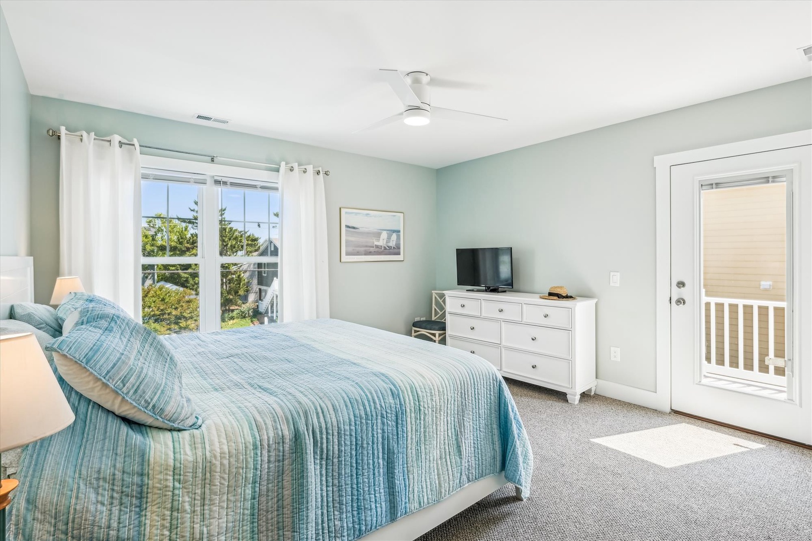 Relax in your tranquil bedroom with soothing mint walls, plush bedding, and private balcony access for morning coffee moments.