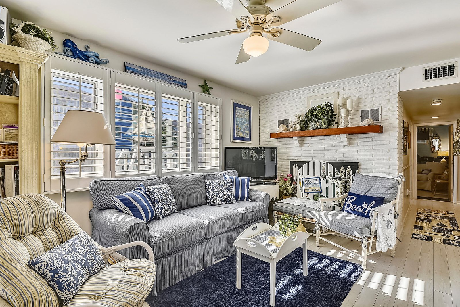 Sink into the plush sofas and unwind in your bright coastal living room, complete with charming nautical touches and a cozy fireplace to set the mood.