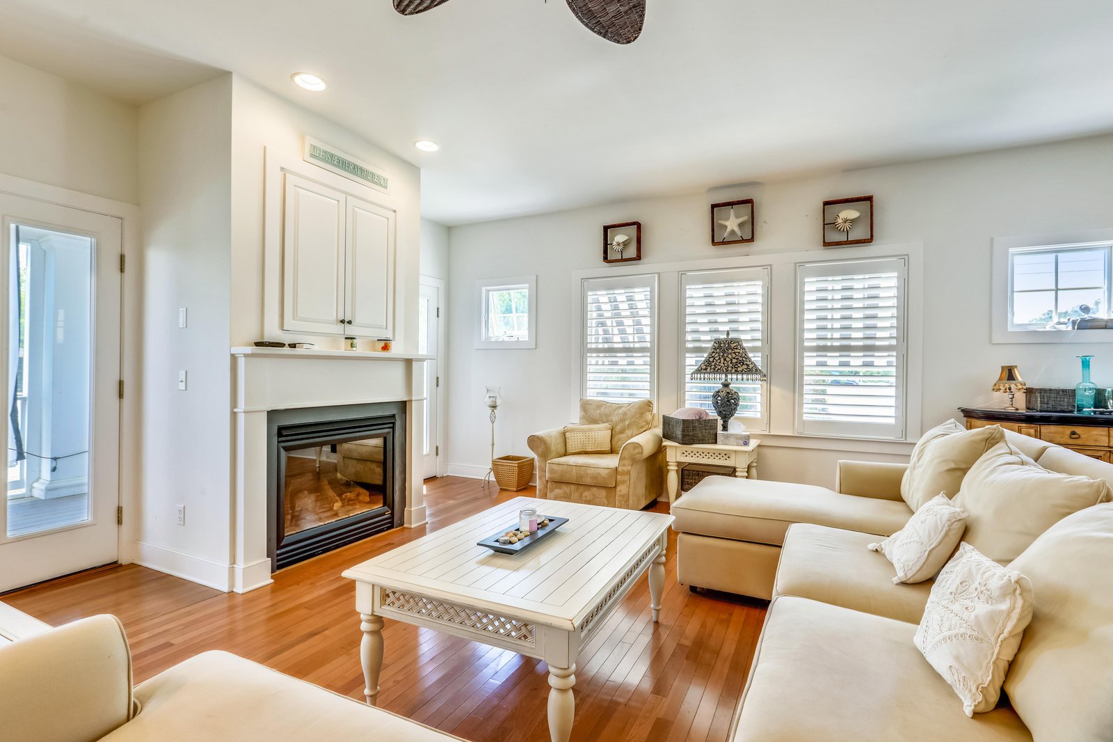 Sink into the plush sofa and let the warmth of the fireplace melt your stress away. With soft coastal decor and gleaming hardwood floors, this inviting living room is your perfect spot to unwind after a day of adventure.