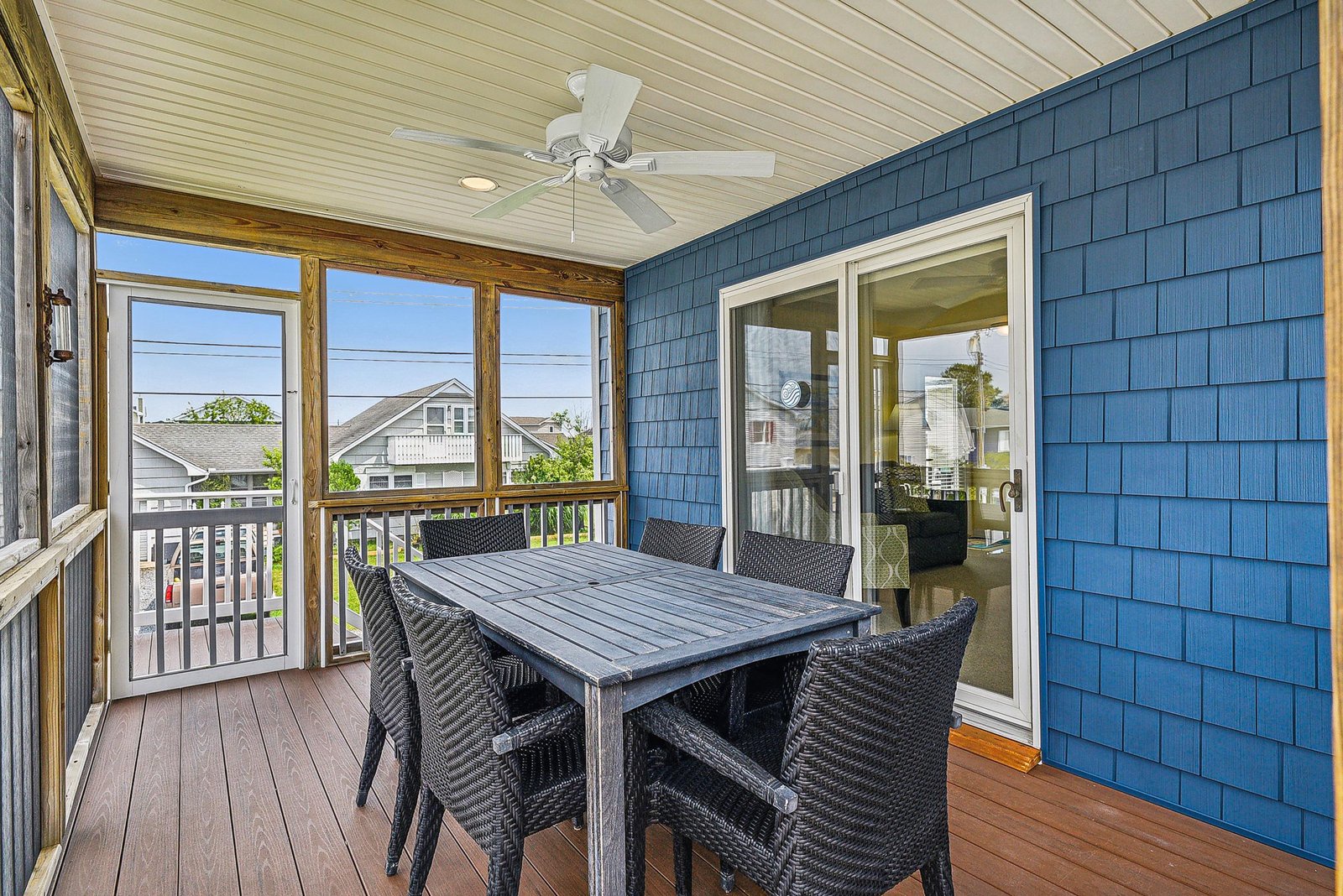Enjoy your morning coffee or a leisurely dinner at this screened porch table, where you're sheltered yet still feel the fresh air and hear neighborhood sounds through the open windows.