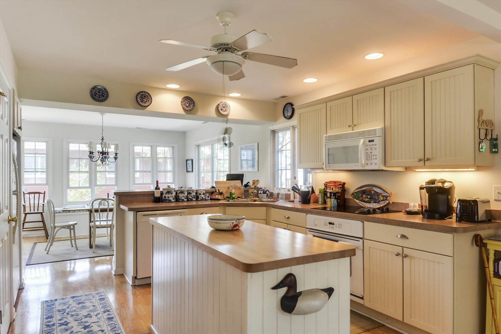 Step into your welcoming kitchen, where warm wood counters and plenty of prep space invite you to cook up your favorite vacation meals with a coastal-inspired touch.