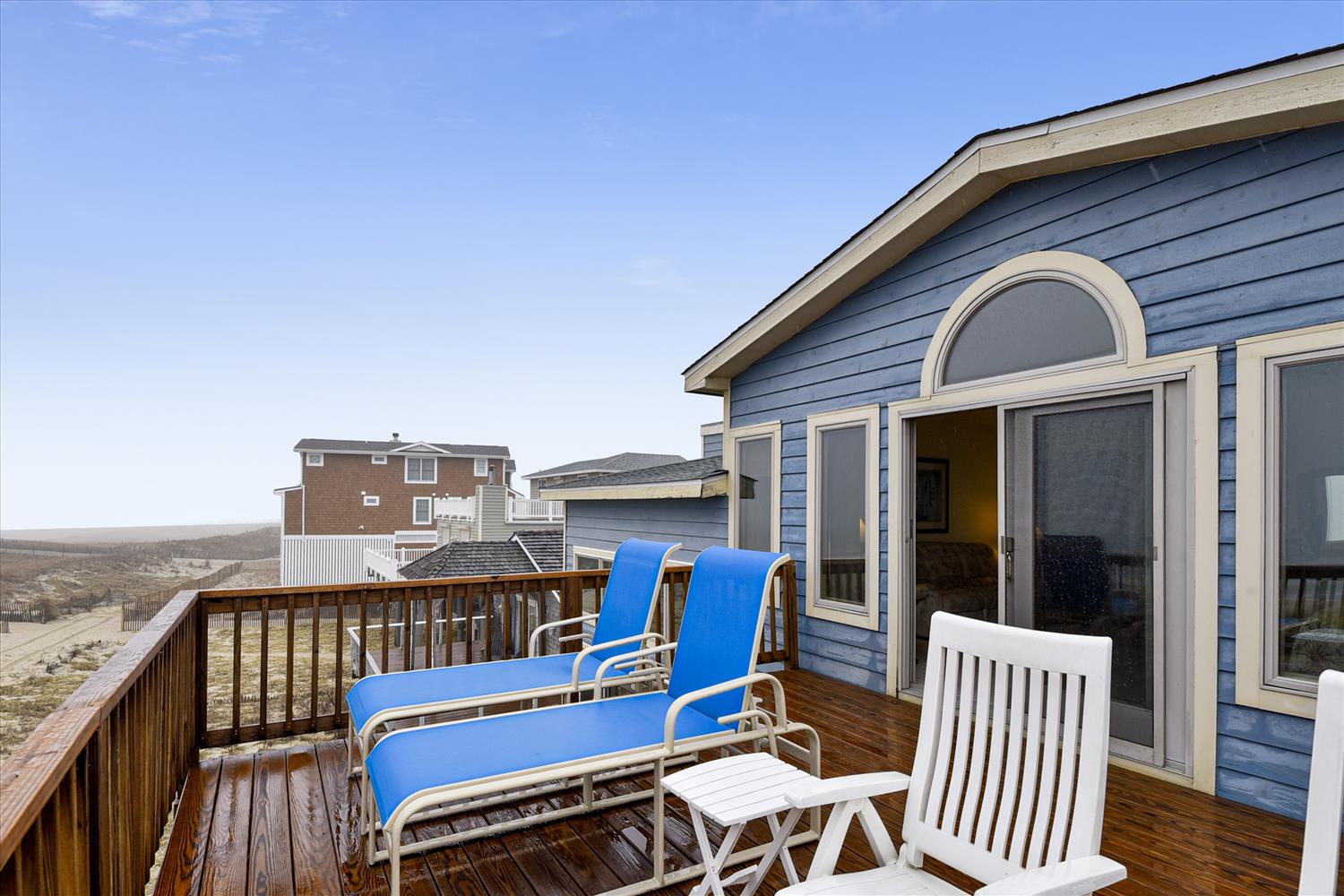 This charming blue coastal cottage offers your own private deck with loungers, perfect for soaking up the sunshine and ocean breezes just steps from the sand.