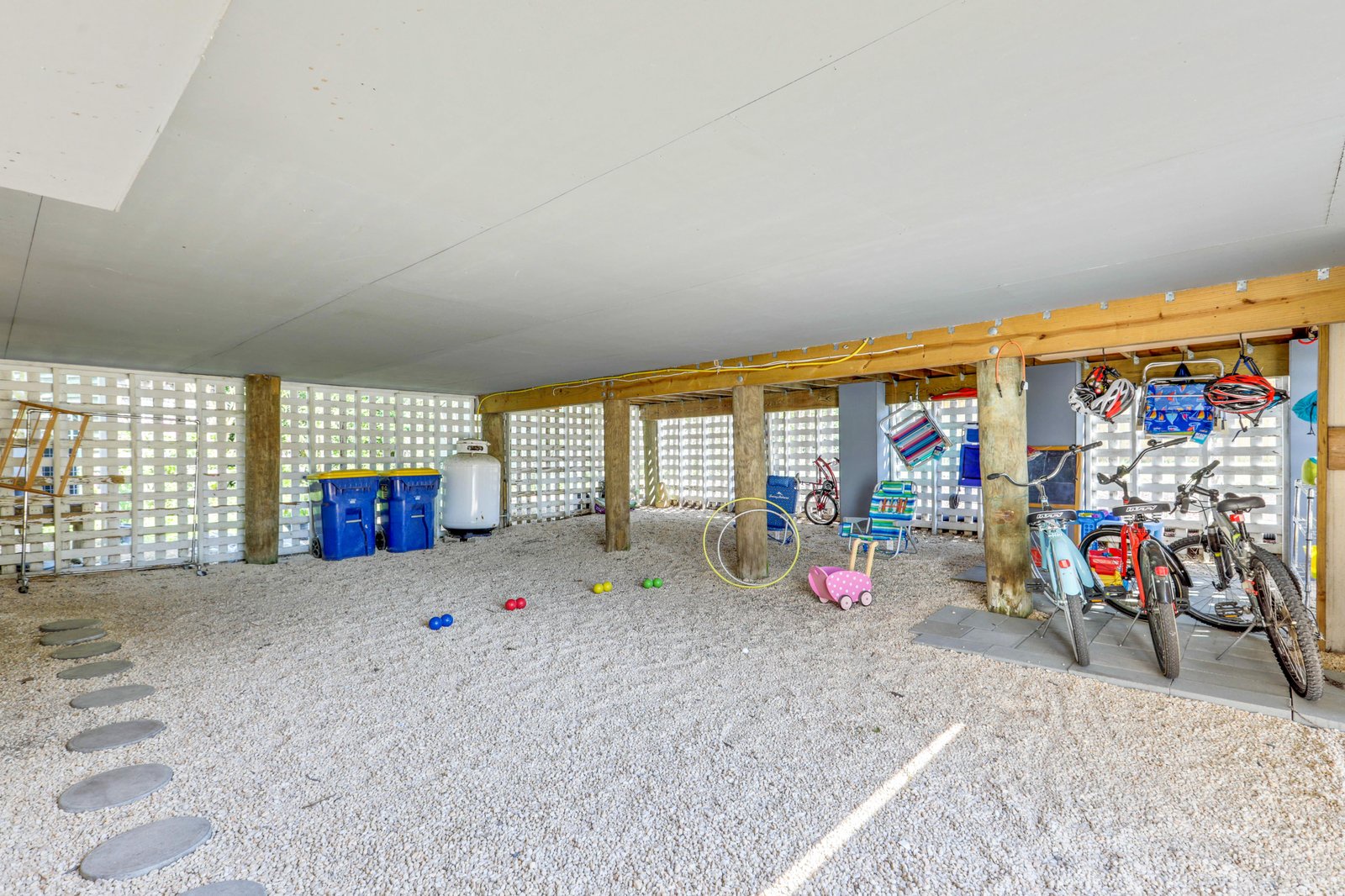 Covered storage area beneath the property, with beach gear and bikes ready for your island adventures.