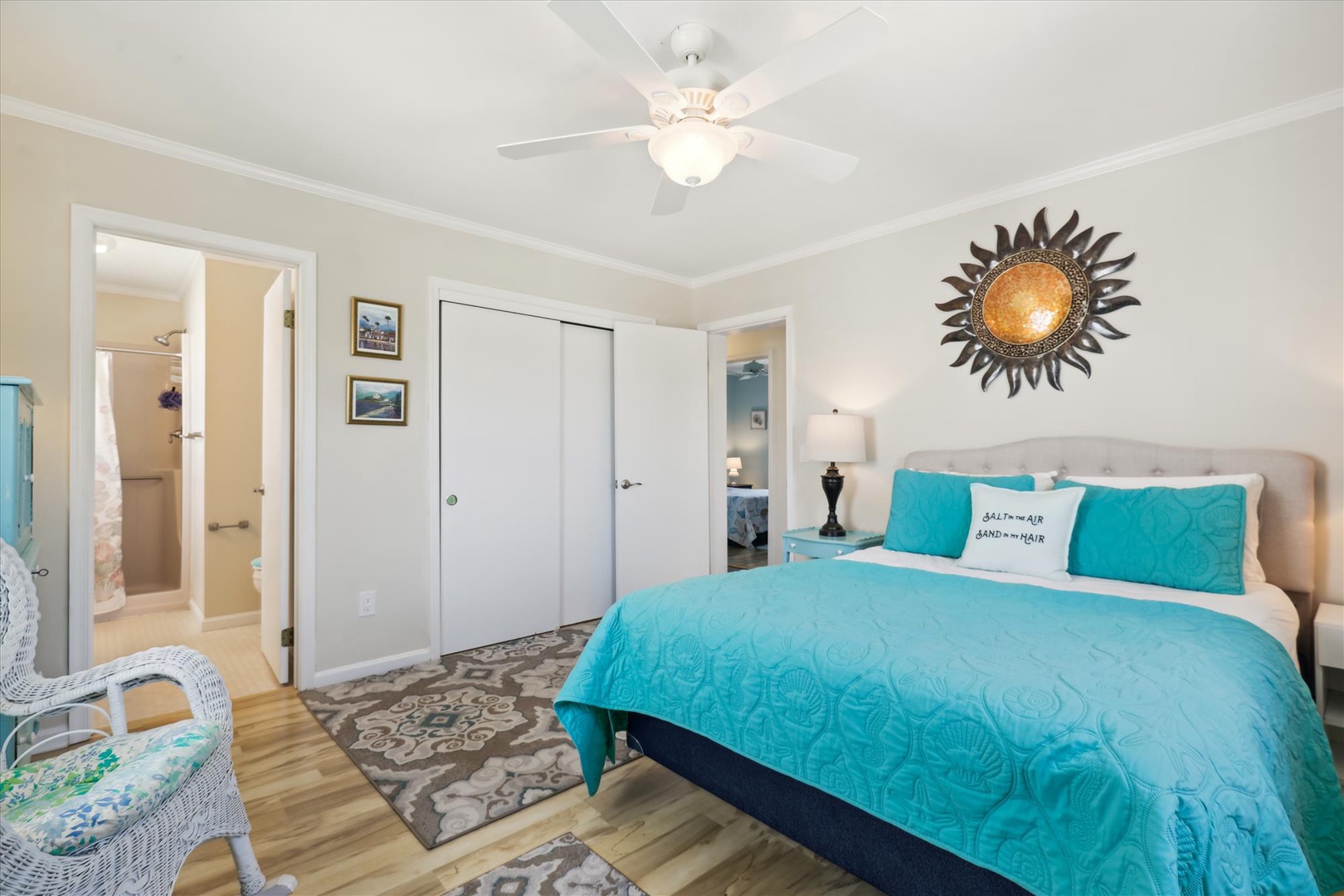 Sink into plush bedding and unwind under the soothing ceiling fan, with your private bathroom just steps away for effortless convenience.
