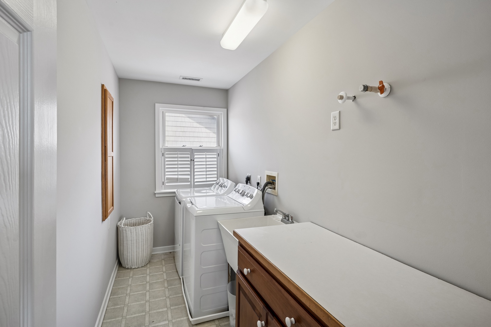 Your bright laundry room makes wash day a breeze with full-size machines and a convenient folding counter.