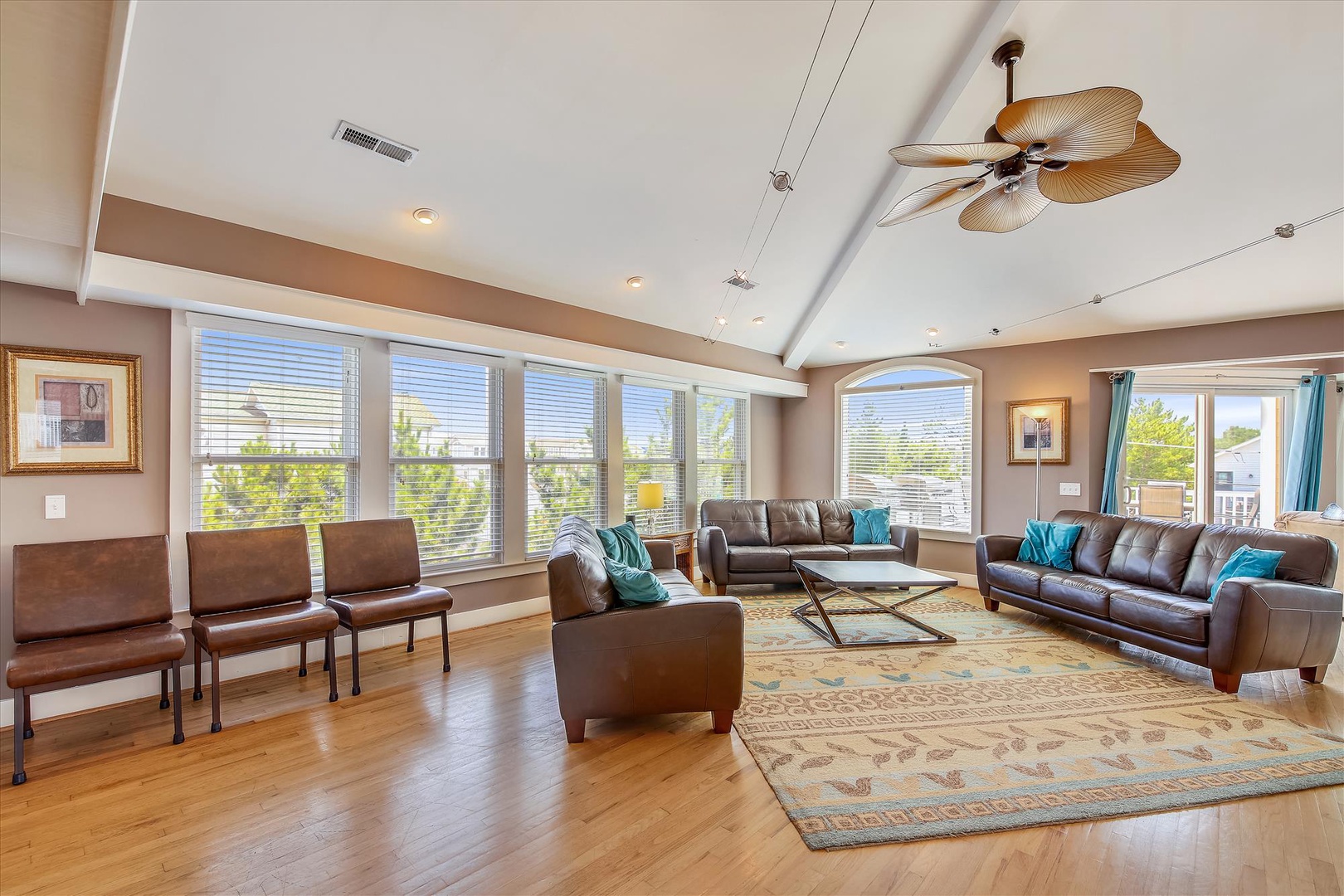 Relax in your spacious living room with soaring ceilings, abundant natural light, and comfortable leather seating—perfect for gathering with loved ones after a day of exploring.