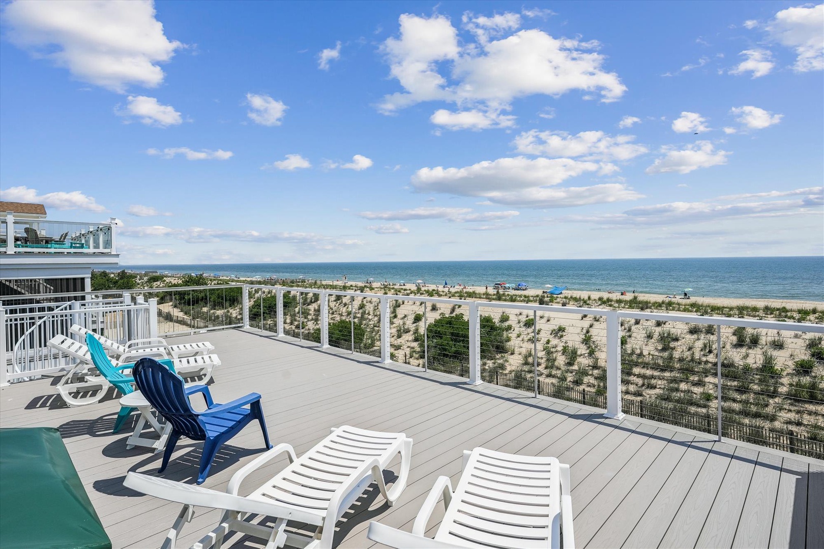 A spacious beachfront deck overlooks pristine sandy shores and sparkling ocean, offering the perfect spot to soak up coastal breezes and stunning sea views during your stay.