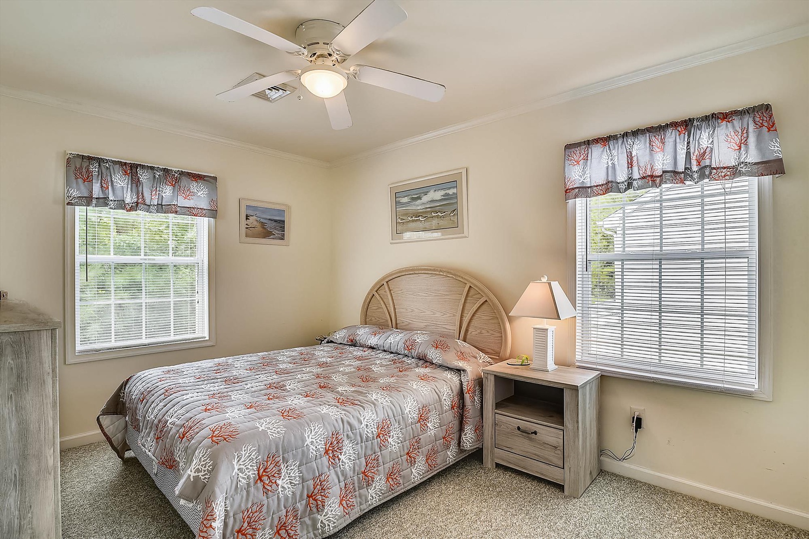 Drift off in your coastal-inspired bedroom with soft natural light, a ceiling fan for gentle breezes, and calming coral-themed decor that brings the beach to your doorstep.