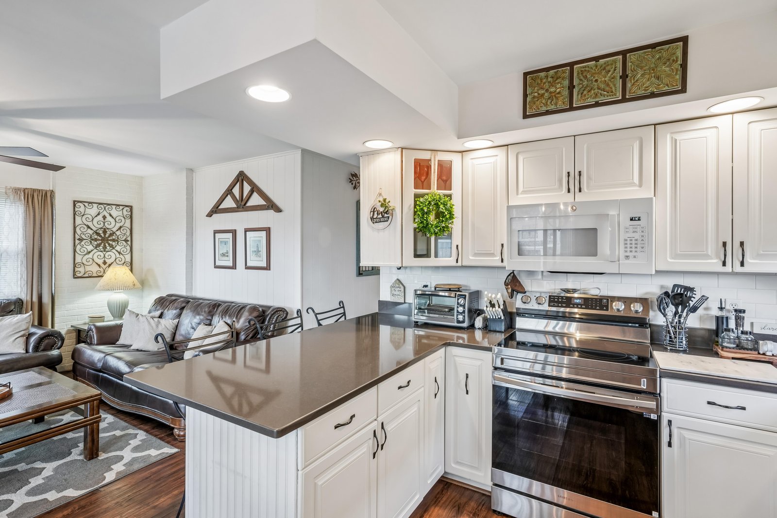 Picture yourself preparing meals in this bright, fully-equipped kitchen with modern appliances and ample counter space. The open layout flows into a cozy living area—perfect for gathering with loved ones during your stay.