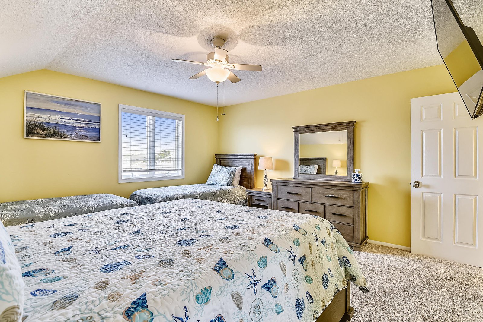 Unwind in your bright, coastal-themed bedroom, where twin beds and soft bedding promise restful nights after a day of adventure.