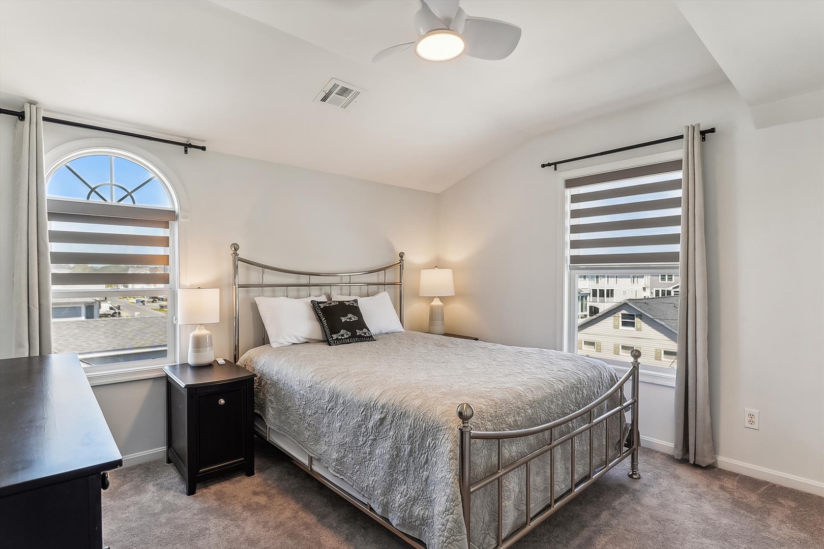 Sink into your comfortable bed and wake to soft light filtering through stylish window treatments, while gentle ceiling fan breezes keep you cool all night.