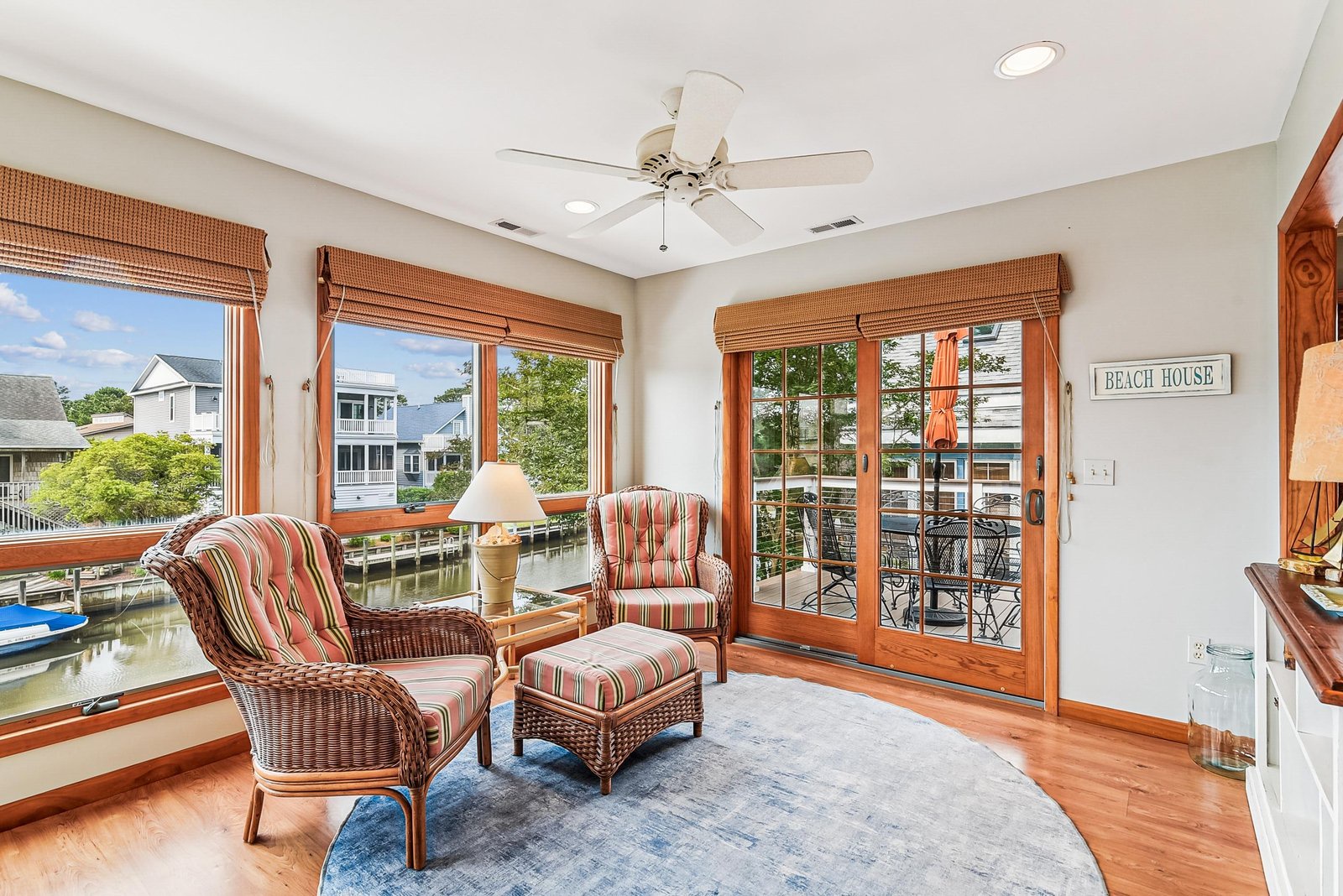 Step into your own waterfront retreat with panoramic views of the canal and neighboring homes. Relax in the sunlit seating area, enjoy the gentle breeze from the ceiling fan, and step out onto your private balcony to soak in the serene scenery.