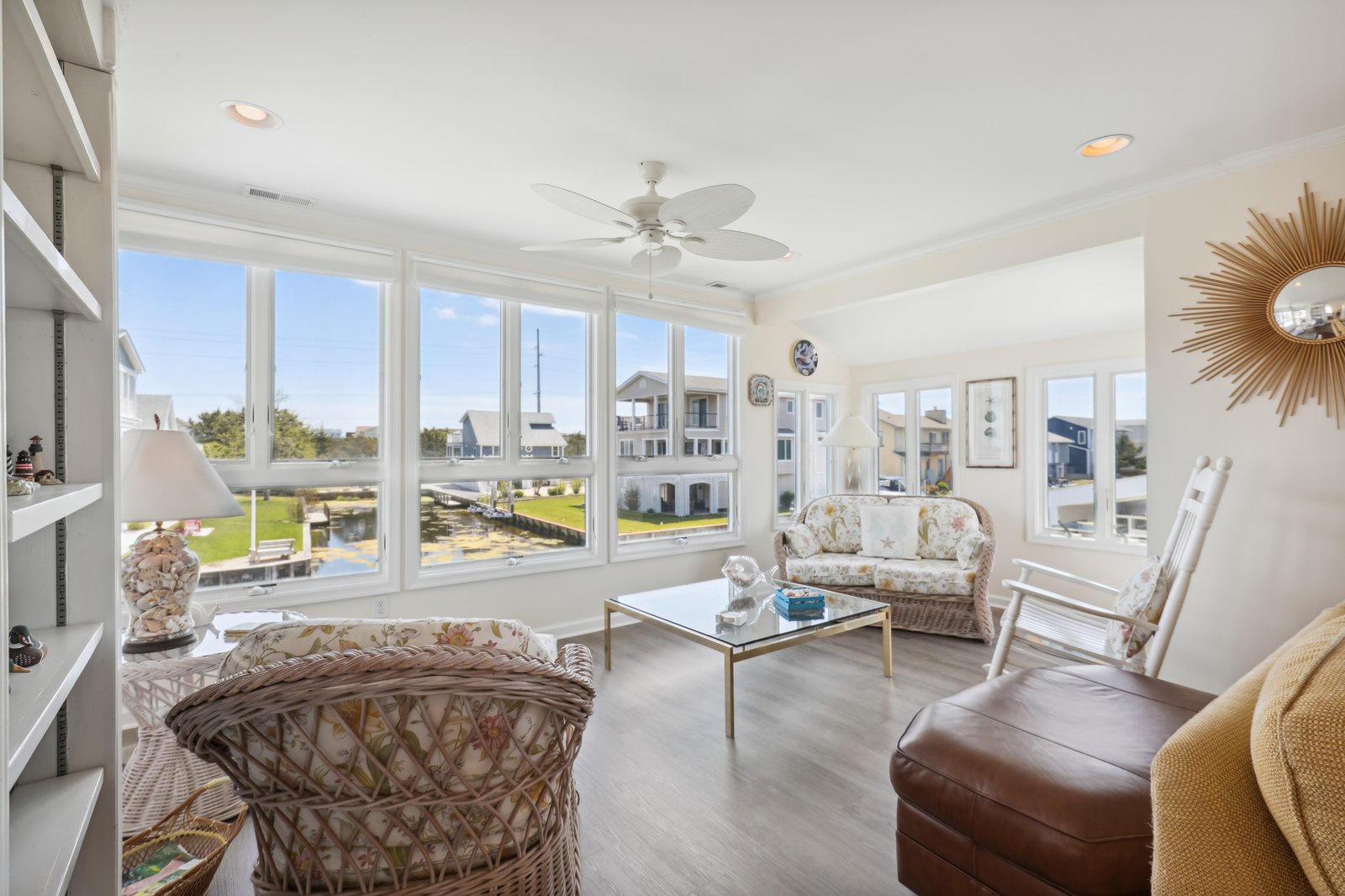 Sink into comfortable seating as natural light floods through floor-to-ceiling windows, offering peaceful views of the surrounding neighborhood. Your living space is bright, airy, and perfect for unwinding after a day of exploring.