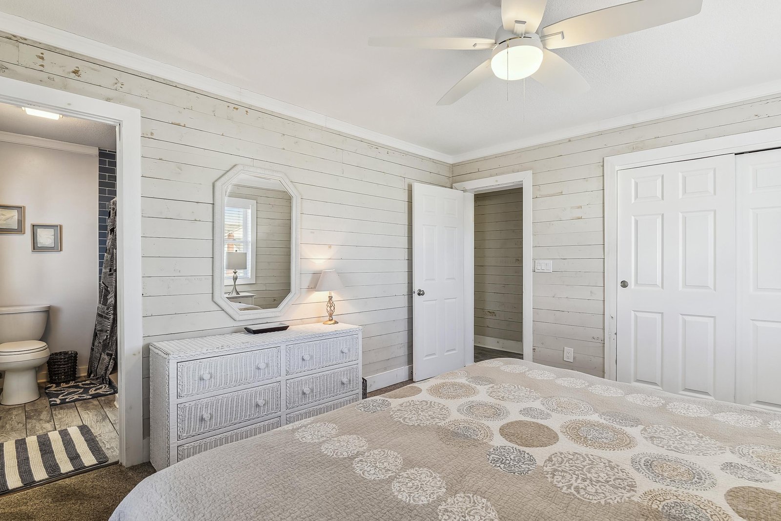 Drift off in this serene coastal bedroom where whitewashed shiplap walls and soft linens create your perfect beach cottage retreat.