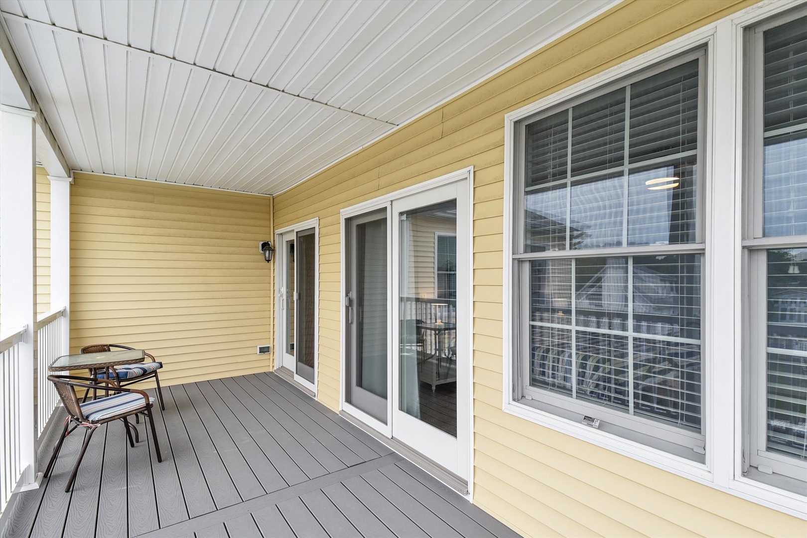 Step outside to your private covered balcony, where a cozy bistro set awaits your morning coffee or evening unwind. Fresh air and relaxation, just beyond your door.