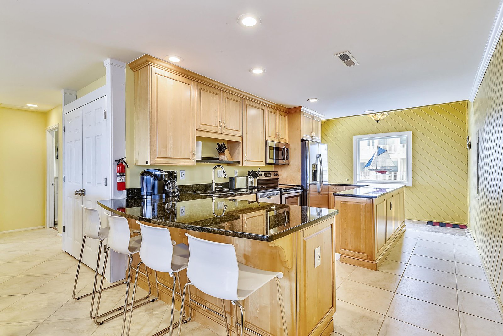 A fully equipped kitchen with ample counter space, modern appliances, and a breakfast bar where you can enjoy your morning coffee or plan the day's adventures.