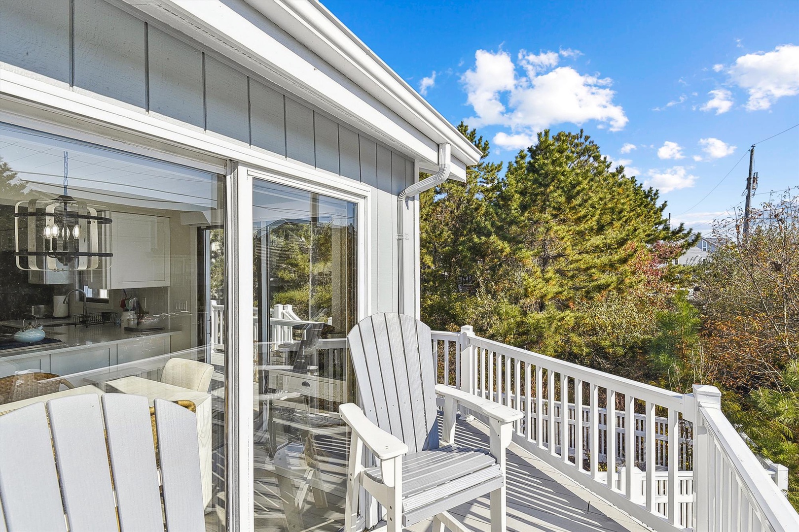 Scenic elevated deck overlooks lush greenery, offering a peaceful outdoor retreat where you can relax in the fresh air and soak up serene views.