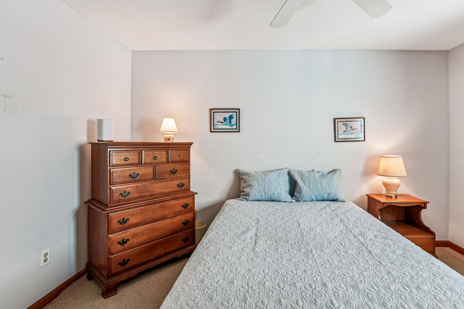 Settle into your peaceful bedroom retreat with plush bedding, warm bedside lighting, and coastal-inspired artwork that invites restful nights.