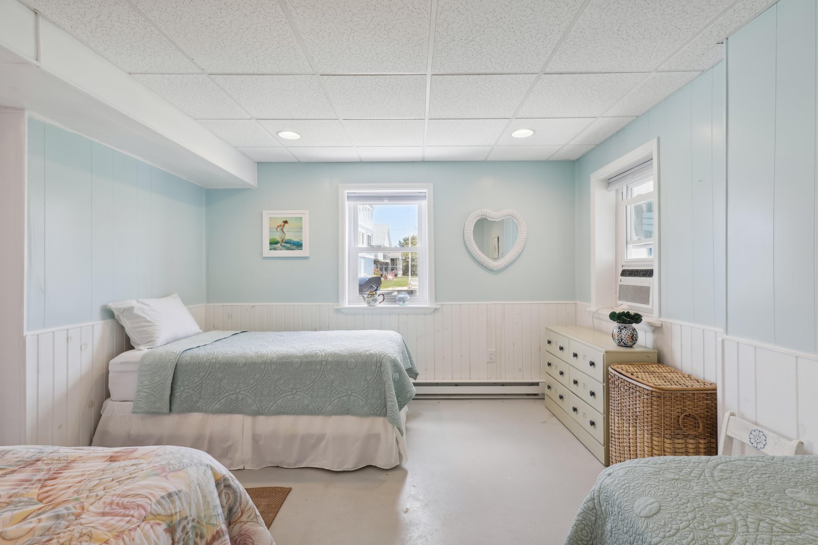 Unwind in your soothing coastal bedroom, where soft aqua walls and beachy accents create a peaceful retreat. Natural light spills through the window, inviting you to relax and recharge.