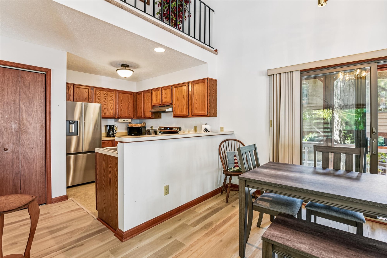 Your open-concept space invites relaxed living, with a fully-equipped kitchen, cozy dining area, and upstairs loft overlooking bright, hardwood-warmed rooms—perfect for memorable family gatherings.
