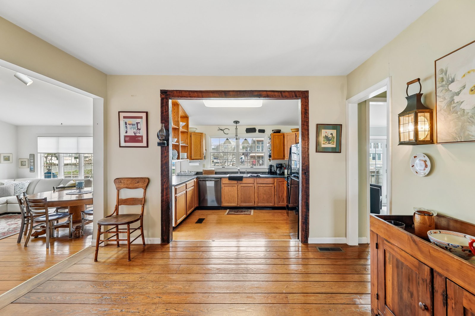 Step into this inviting home with gleaming hardwood floors and charming wood-framed doorways leading to your fully-equipped kitchen. The warm tones and open layout create a welcoming space where you'll feel instantly at ease.