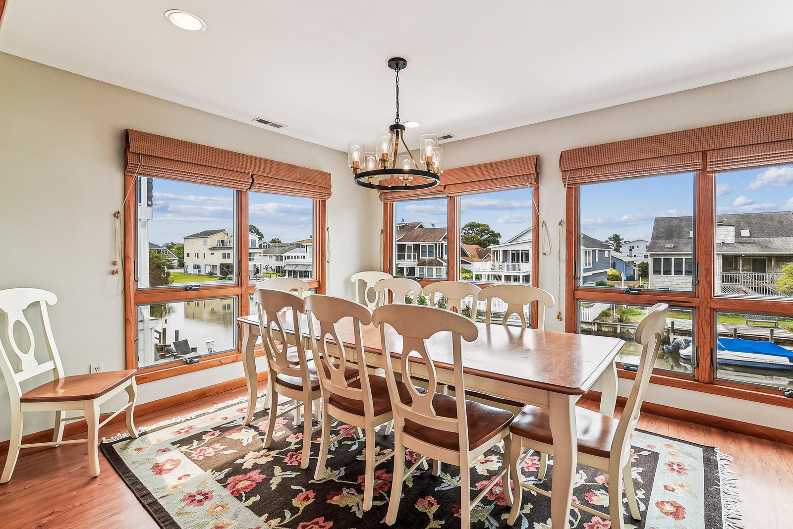 Gather around the elegant dining table and enjoy waterfront views through every window, perfect for memorable meals with your group in this bright, welcoming space.