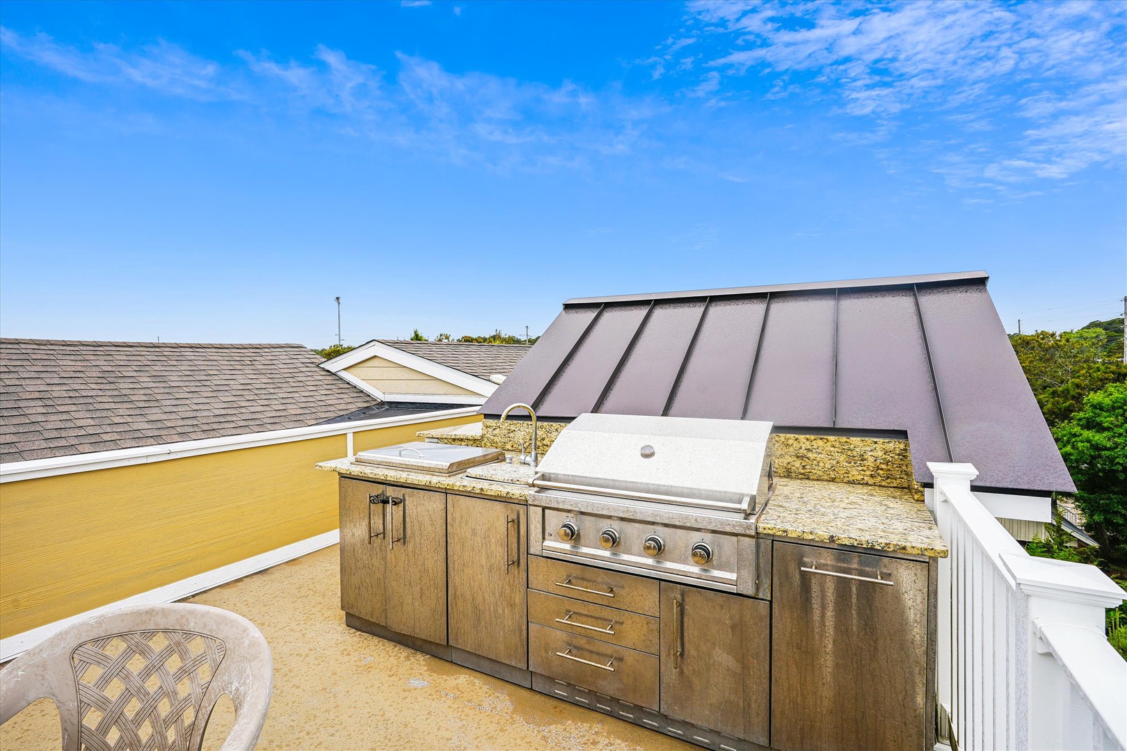 Grill with a view on your private rooftop terrace, where sunny skies and a top-of-the-line outdoor kitchen set the stage for unforgettable meals.