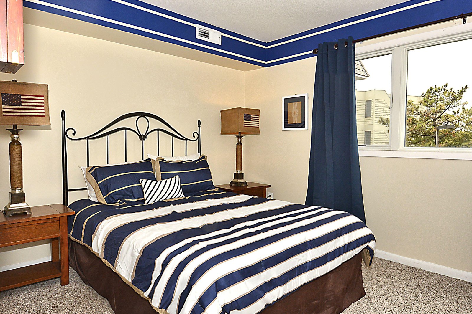 Sink into crisp, nautical-themed linens and wake to gentle natural light streaming through your window, creating the perfect retreat after a day at the beach.
