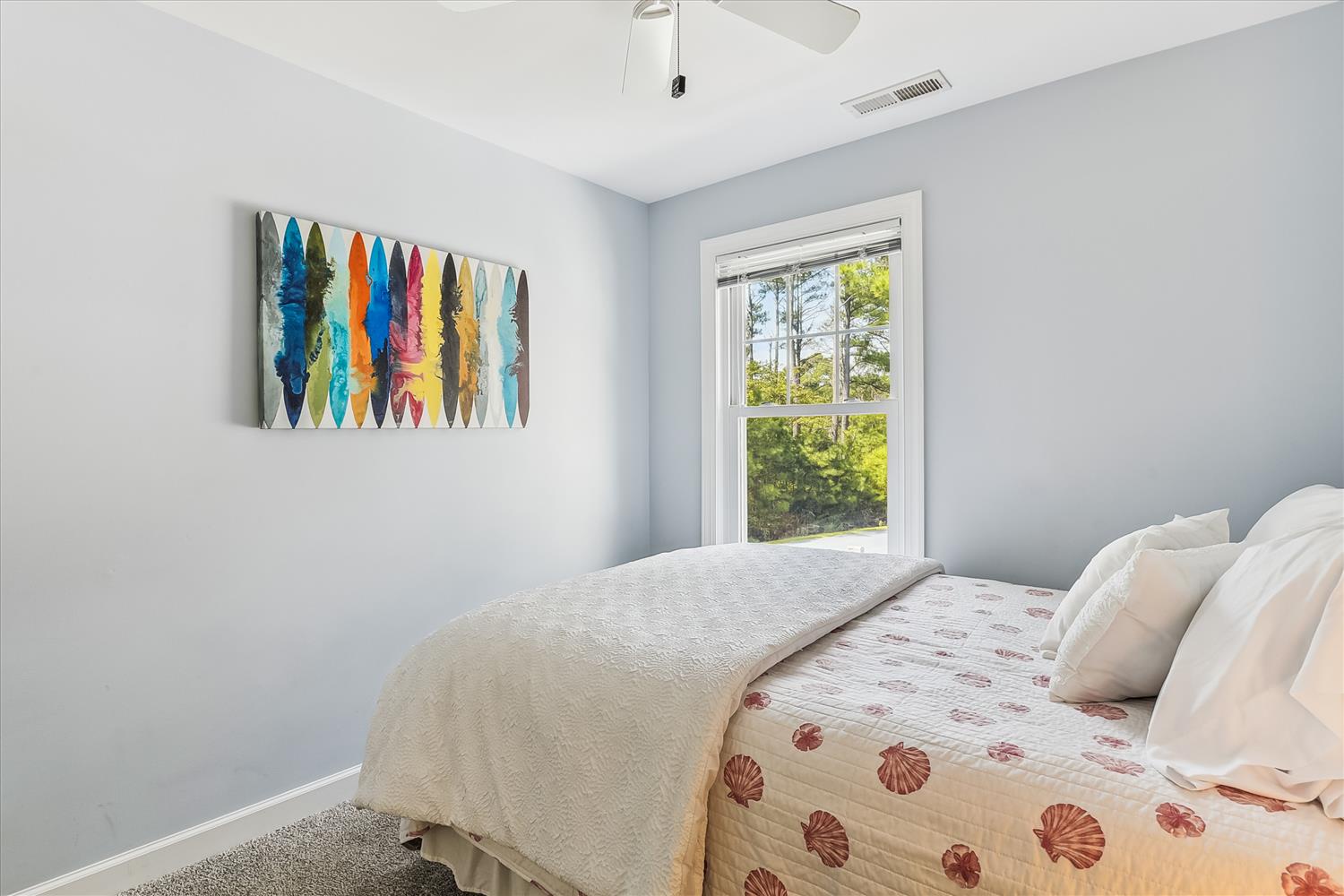 Drift off in this serene bedroom, where soft coastal colors and natural light create your peaceful retreat after a day of adventure.