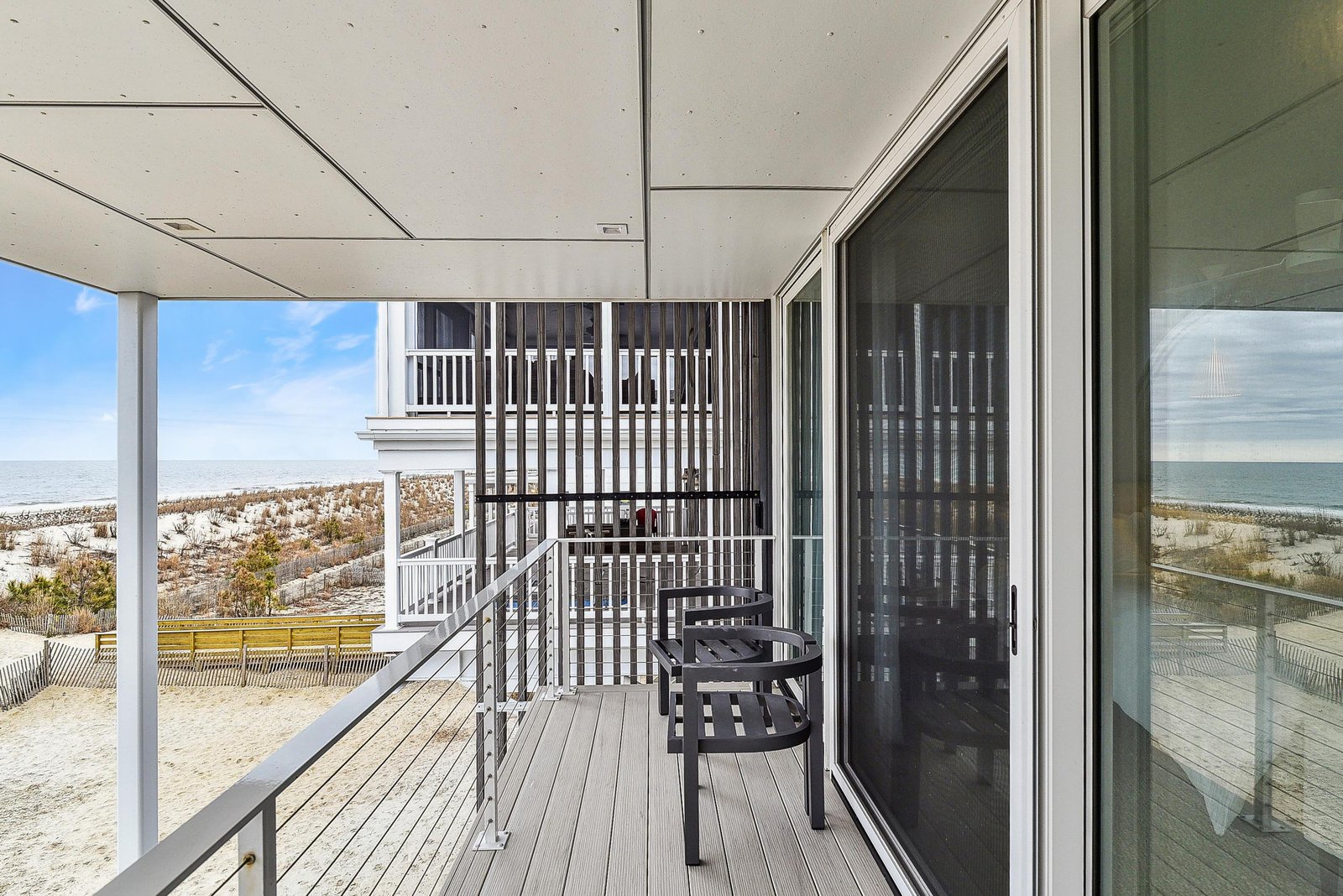 Step onto your private balcony and take in the stunning ocean and beach views. The covered terrace offers comfortable seating and direct sightlines to the sandy shore and rolling waves.
