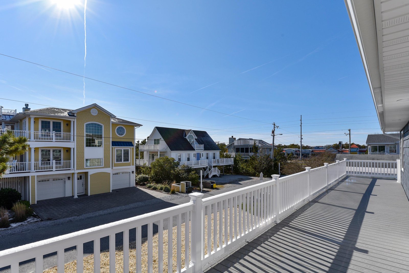 A spacious residential neighborhood with colorful beach houses and coastal charm visible from the property.